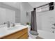 Bathroom featuring modern fixtures, a shower with a gray curtain, and wood cabinets at 8349 Spruce Bay Ave, Las Vegas, NV 89178