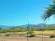 Expansive community green space with lush landscaping and a building with a church steeple set against a mountain backdrop at 8349 Spruce Bay Ave, Las Vegas, NV 89178