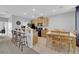 Open kitchen area features a breakfast bar, light wood cabinetry, and a dining table at 8349 Spruce Bay Ave, Las Vegas, NV 89178