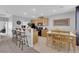 Bright kitchen and dining area with dark appliances, barstool seating, and a modern table and chairs at 8349 Spruce Bay Ave, Las Vegas, NV 89178