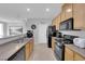 Galley kitchen features light wood cabinets and black appliances at 8349 Spruce Bay Ave, Las Vegas, NV 89178