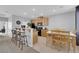 Open kitchen area features a breakfast bar, light wood cabinetry, and a dining table at 8349 Spruce Bay Ave, Las Vegas, NV 89178