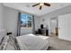 Comfortable main bedroom with natural light, TV, ceiling fan, and neutral color at 8349 Spruce Bay Ave, Las Vegas, NV 89178