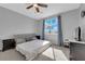 Bright main bedroom features a ceiling fan, large window, and neutral paint color at 8349 Spruce Bay Ave, Las Vegas, NV 89178