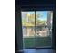 Sliding glass doors to private balcony with black wrought iron and artificial grass at 9050 W Warm Springs Rd # 2016, Las Vegas, NV 89148