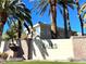 A beautiful exterior view of this home with palm trees and a private front yard at 9050 W Warm Springs Rd # 2016, Las Vegas, NV 89148