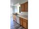 This kitchen features wooden cabinets and a white dishwasher with stainless steel double sinks at 9050 W Warm Springs Rd # 2016, Las Vegas, NV 89148