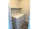 A laundry room with a washer, dryer, and a single shelf at 9050 W Warm Springs Rd # 2016, Las Vegas, NV 89148