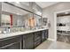 Elegant bathroom featuring a dual sink vanity, a large mirror, and custom closet space at 920 Claystone Ridge Ave, North Las Vegas, NV 89084