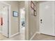 Bright hallway featuring tile flooring, neutral colored walls, and white doors at 920 Claystone Ridge Ave, North Las Vegas, NV 89084