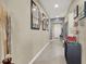 Inviting hallway featuring neutral walls, modern lighting, decor, and tile flooring at 920 Claystone Ridge Ave, North Las Vegas, NV 89084