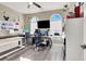 Bright home office equipped with two arched windows, a desk, and shelving for an efficient workspace at 920 Claystone Ridge Ave, North Las Vegas, NV 89084