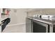 Modern laundry room with stainless steel washer and dryer, complemented by practical shelving for storage at 920 Claystone Ridge Ave, North Las Vegas, NV 89084