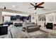 Open living room with a ceiling fan and modern decor flowing into the kitchen at 920 Claystone Ridge Ave, North Las Vegas, NV 89084