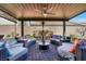 Serene covered patio with comfortable seating around a central table at 920 Claystone Ridge Ave, North Las Vegas, NV 89084