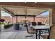 Relaxing covered patio with comfortable seating and a ceiling fan at 920 Claystone Ridge Ave, North Las Vegas, NV 89084