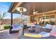 Inviting covered patio featuring ample seating, ceiling fans, and seamless transition to indoor living spaces at 920 Claystone Ridge Ave, North Las Vegas, NV 89084