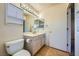 Bathroom with a single sink, light wood cabinets, and toilet at 9421 Gold Mountain Dr, Las Vegas, NV 89134