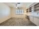 Versatile bedroom with built-in desk and shelving, ceiling fan, and plantation shutters for natural light at 9421 Gold Mountain Dr, Las Vegas, NV 89134