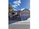 Charming single-story home with a well-manicured front yard, a two-car garage, and a red tile roof at 9421 Gold Mountain Dr, Las Vegas, NV 89134