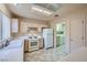 Bright kitchen with white appliances, neutral tile floors, and plenty of cabinet space at 9421 Gold Mountain Dr, Las Vegas, NV 89134