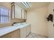 Well-lit laundry room features a washer, dryer, cabinets and counter space near a window with natural light at 9421 Gold Mountain Dr, Las Vegas, NV 89134