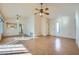 Open-concept living room with light wood floors, ceiling fan, and open to kitchen at 9421 Gold Mountain Dr, Las Vegas, NV 89134