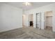 Carpeted bedroom featuring white walls with a closet and bathroom entrance at 965 Nevada State Dr # 39201, Henderson, NV 89002