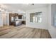 Open living space with wood-look floors, recessed lights, and an island connecting to the kitchen at 965 Nevada State Dr # 39201, Henderson, NV 89002