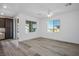 Living room featuring wood-look floors, recessed lights, and ample natural light from large windows at 965 Nevada State Dr # 39201, Henderson, NV 89002