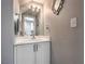 Well-lit half bathroom with a modern vanity and decorative mirror at 9655 Idle Spurs Dr, Las Vegas, NV 89123