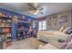 Stylish bedroom with navy walls, shelving, ceiling fan, and a comfortable bed, perfect for relaxation and rest at 9655 Idle Spurs Dr, Las Vegas, NV 89123