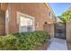 A glimpse of the side and back exterior featuring a gate and stucco walls, providing privacy and charm at 9655 Idle Spurs Dr, Las Vegas, NV 89123