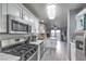 Open kitchen with stainless appliances, white cabinets, and a view of the dining area at 9655 Idle Spurs Dr, Las Vegas, NV 89123