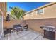 Inviting patio with a grill, brick walls, seating and tiled flooring, perfect for outdoor dining and relaxation at 9655 Idle Spurs Dr, Las Vegas, NV 89123