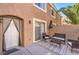 The private back patio features outdoor seating, and access to the home through the sliding glass door at 9655 Idle Spurs Dr, Las Vegas, NV 89123