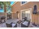 Cozy patio area with a grill, outdoor seating, and privacy fence, ideal for enjoying outdoor living and entertainment at 9655 Idle Spurs Dr, Las Vegas, NV 89123