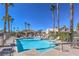 Resort-style community pool with lounge chairs, palm trees, and clear blue water, offering a perfect spot to unwind at 9655 Idle Spurs Dr, Las Vegas, NV 89123