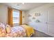 Sunlit bedroom featuring cheerful décor, colorful shelving, and a window with golden curtains at 10148 Mulberry Ridge St # 38, Las Vegas, NV 89141