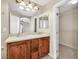 Bright bathroom features a double sink vanity with wooden cabinets and a walk-in closet at 1016 Douglas Flat Pl, Las Vegas, NV 89138