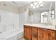 Bathroom with a tub-shower combo, double sink vanity and a large mirror at 1016 Douglas Flat Pl, Las Vegas, NV 89138