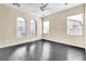 Well-lit bedroom with hardwood floors, multiple windows providing natural light, and a cozy atmosphere at 1016 Douglas Flat Pl, Las Vegas, NV 89138