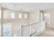 Bright hallway with a view of the staircase, multiple windows and access to a bathroom at 1016 Douglas Flat Pl, Las Vegas, NV 89138