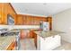 Stylish kitchen with stainless steel appliances, a granite island, and wood cabinets offering a functional cooking space at 1016 Douglas Flat Pl, Las Vegas, NV 89138