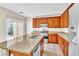 Well-lit kitchen featuring granite counters, stainless steel appliances, and wood cabinetry at 1016 Douglas Flat Pl, Las Vegas, NV 89138