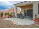 Back patio with concrete tiles featuring furniture and mature landscaping at 10320 Bent Brook Pl, Las Vegas, NV 89134