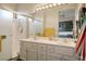 Bright bathroom with double vanity, framed mirrors, and walk-in shower with glass door at 10320 Bent Brook Pl, Las Vegas, NV 89134