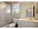 Cozy bathroom featuring a shower, sink, toilet and window, creating a functional space at 10320 Bent Brook Pl, Las Vegas, NV 89134