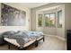 Bedroom with a large black and white photograph and a bay window with neighborhood views at 10320 Bent Brook Pl, Las Vegas, NV 89134