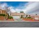 Charming single-story home featuring a well-manicured front yard, two-car garage, and inviting curb appeal at 10320 Bent Brook Pl, Las Vegas, NV 89134